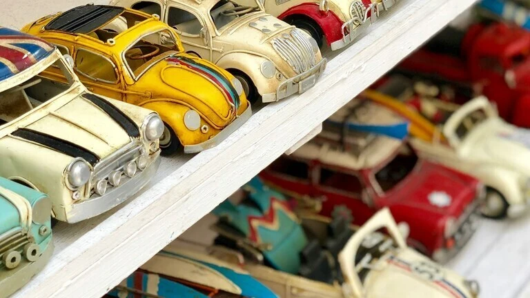Vintage toy cars from the 70s and 80s lined up on a shelf