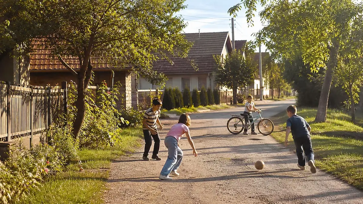 children playing football in the street during the late 1990s