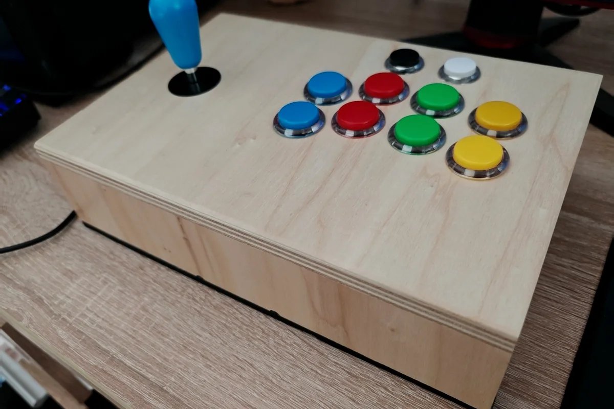 Handmade wooden retro arcade joystick photographed from an angle