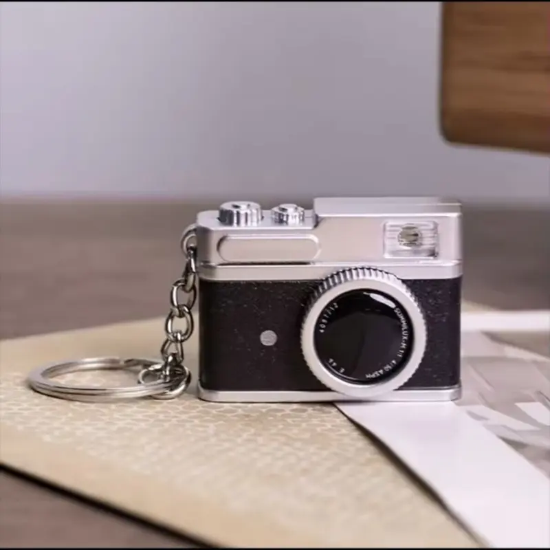 Silver and black vintage camera keychain for analog photography lovers