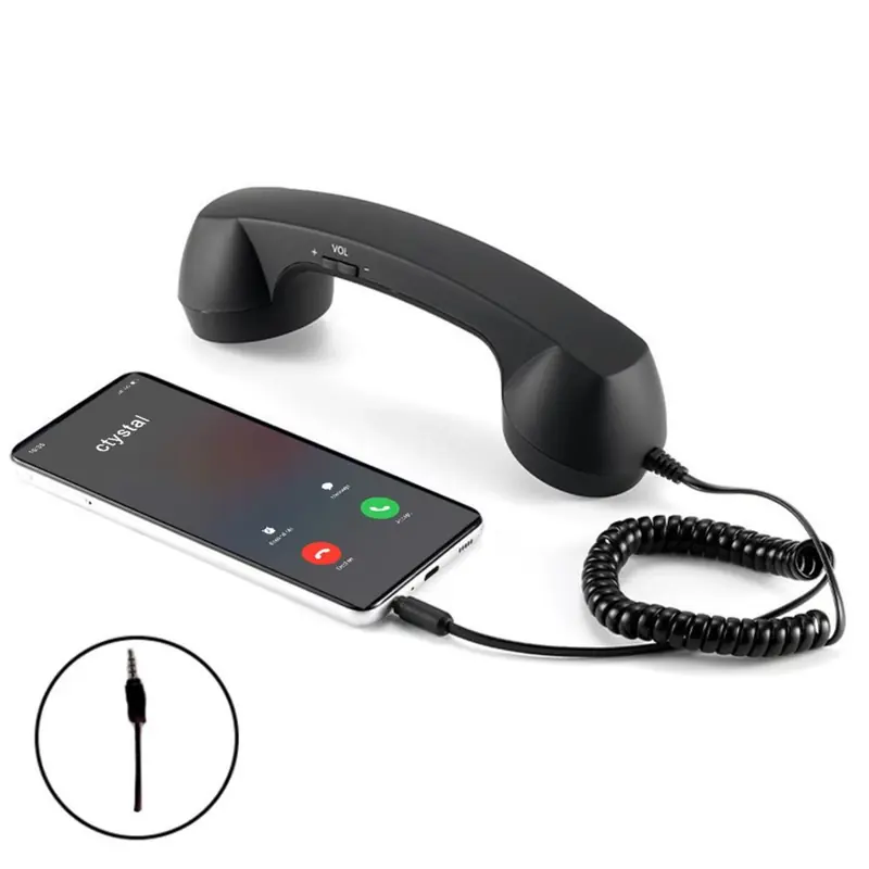 Crna retro telefonska slušalica povezana sa mobilnim telefonom