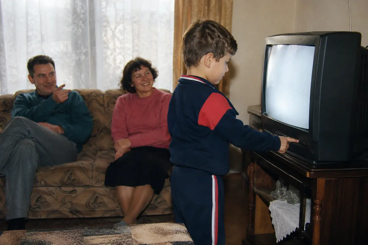 Youngest family member changing the channel on a CRT television