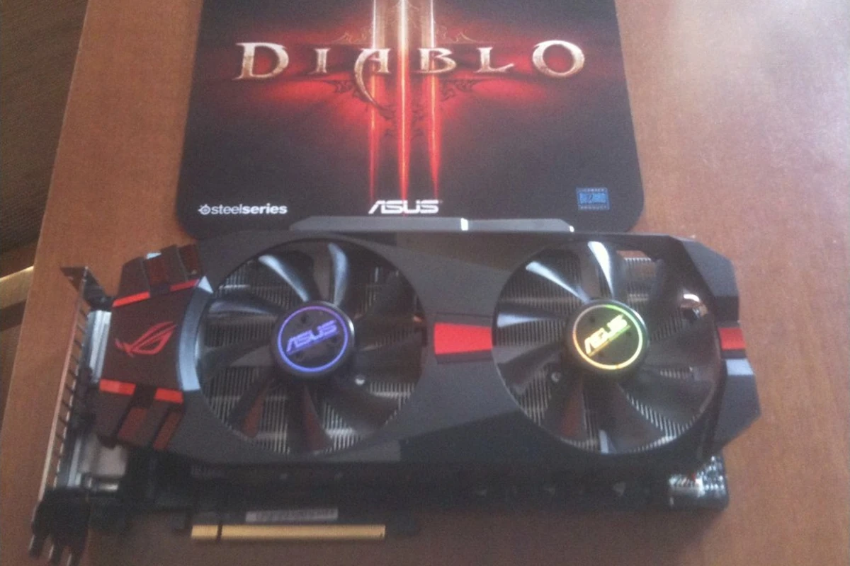 My ASUS ROG graphics card with two fans beside a SteelSeries Diablo III mouse mat.
