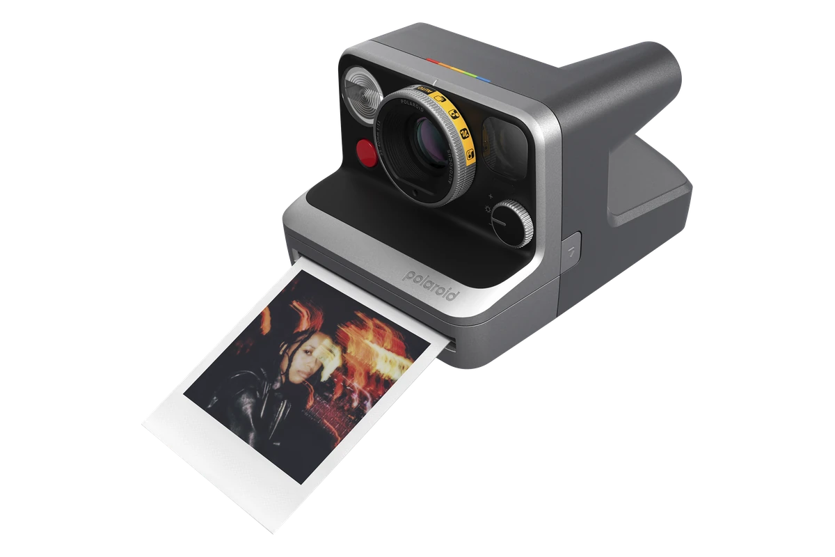 Polaroid Mod camera viewed from an angle with an instant photograph emerging
